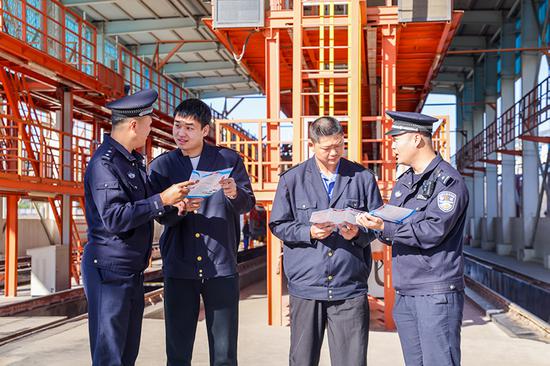 刑警支隊民警向企業(yè)職工發(fā)放宣傳資料并“一對一”講解電詐常識。謝仁古力·托呼提 攝